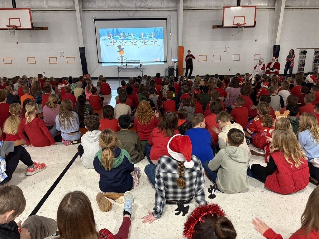 Palmyra Elementary school students in the gym caroling with Santa and Mrs. Claus