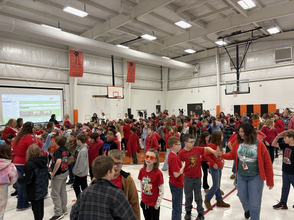 Palmyra Elementary school students in the gym caroling with Santa and Mrs. Claus