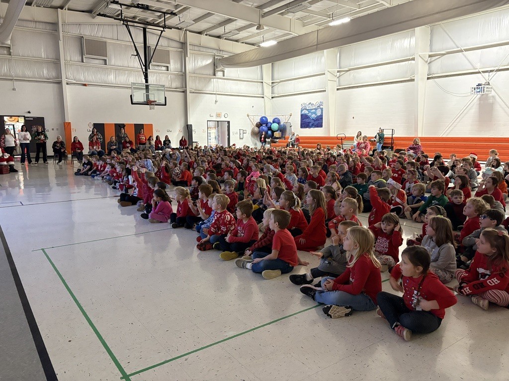 Palmyra Elementary school students in the gym caroling with Santa and Mrs. Claus