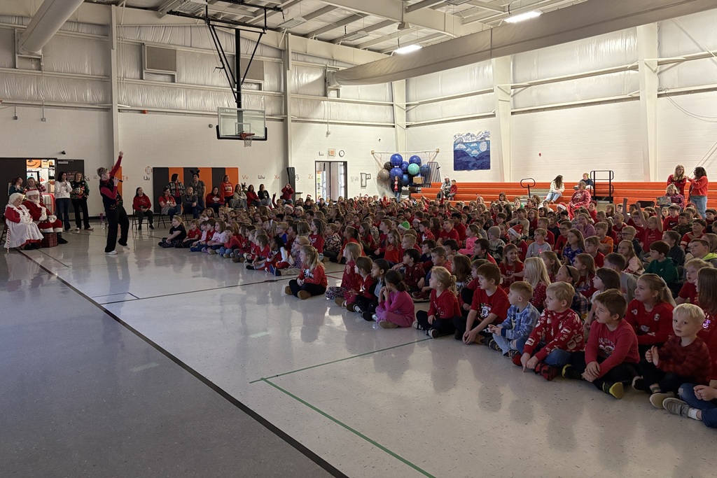 Palmyra Elementary school students in the gym caroling with Santa and Mrs. Claus