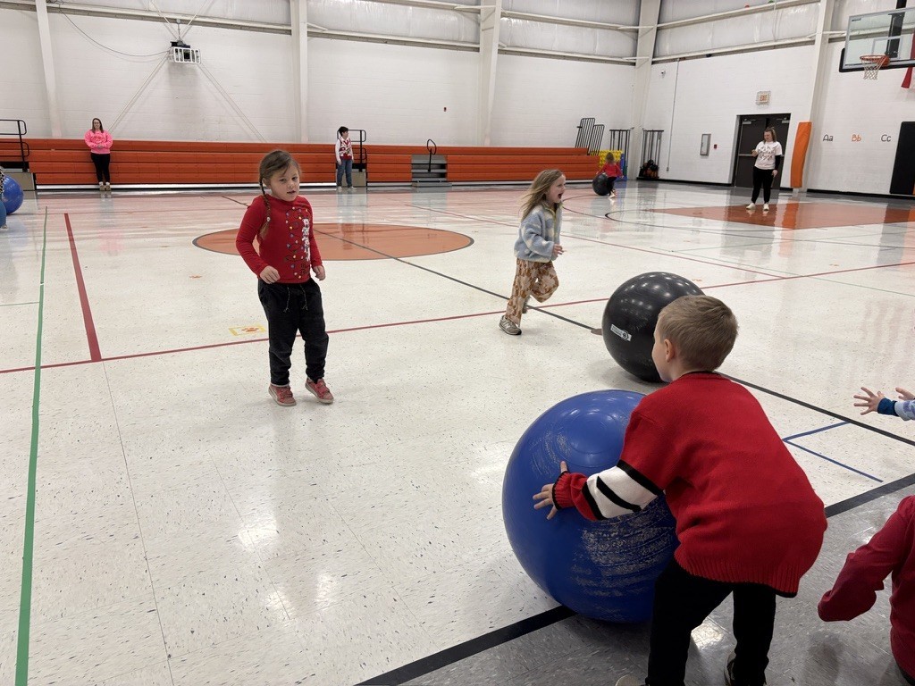 PES Students play reindeer games, rolling giant snowballs in gym