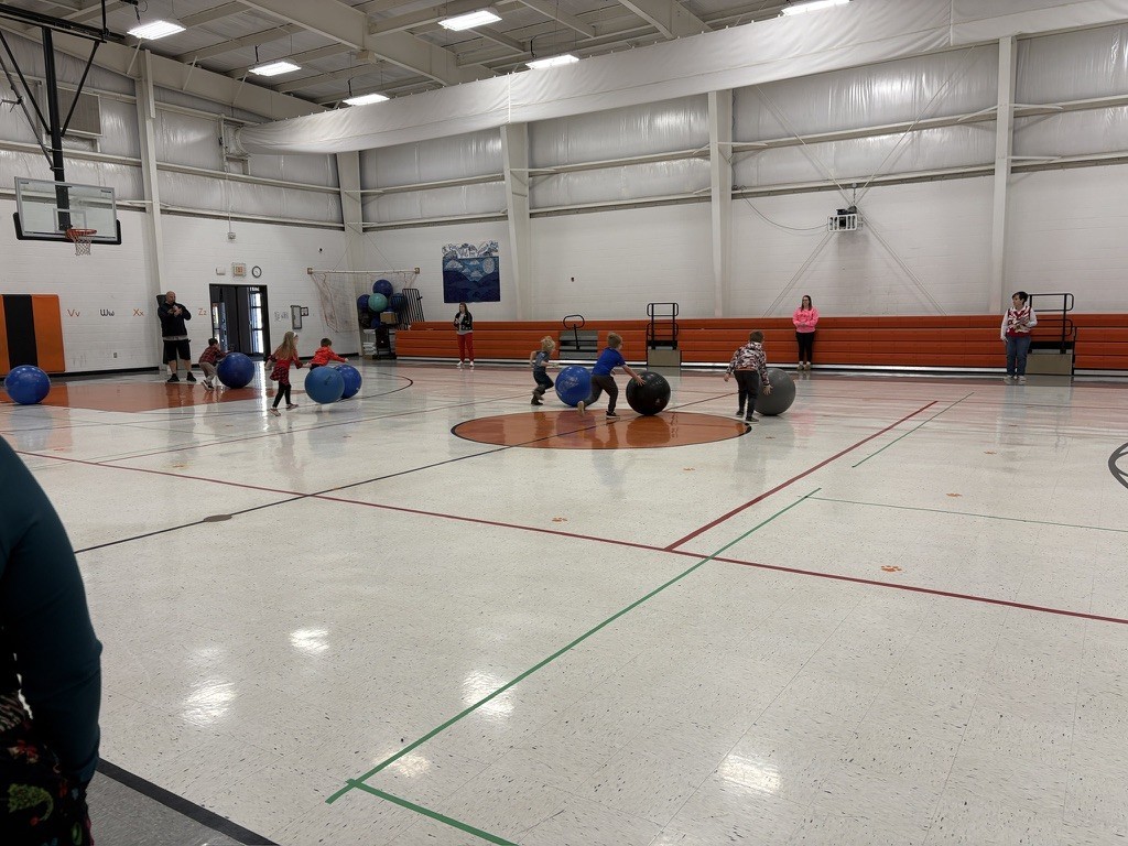 PES Students play reindeer games, rolling giant snowballs in gym