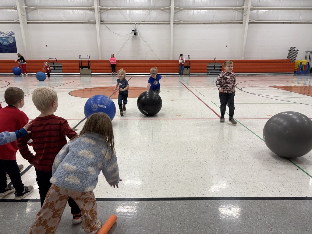 PES Students play reindeer games, rolling giant snowballs in gym