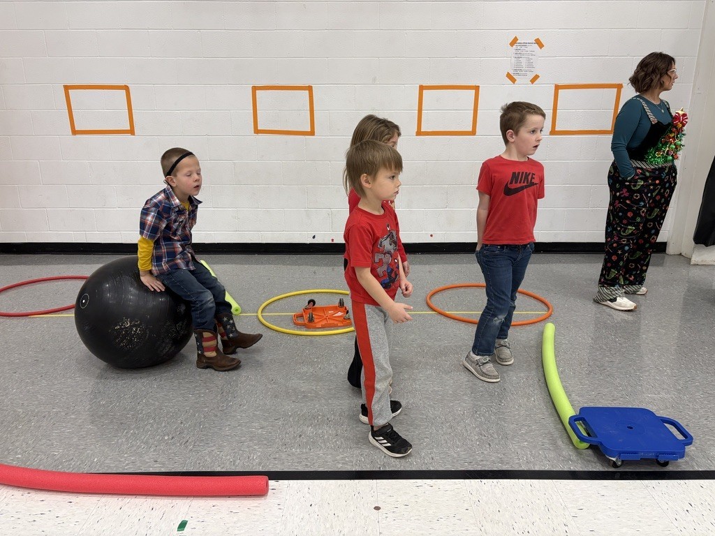 PES Students play reindeer games, rolling giant snowballs in gym