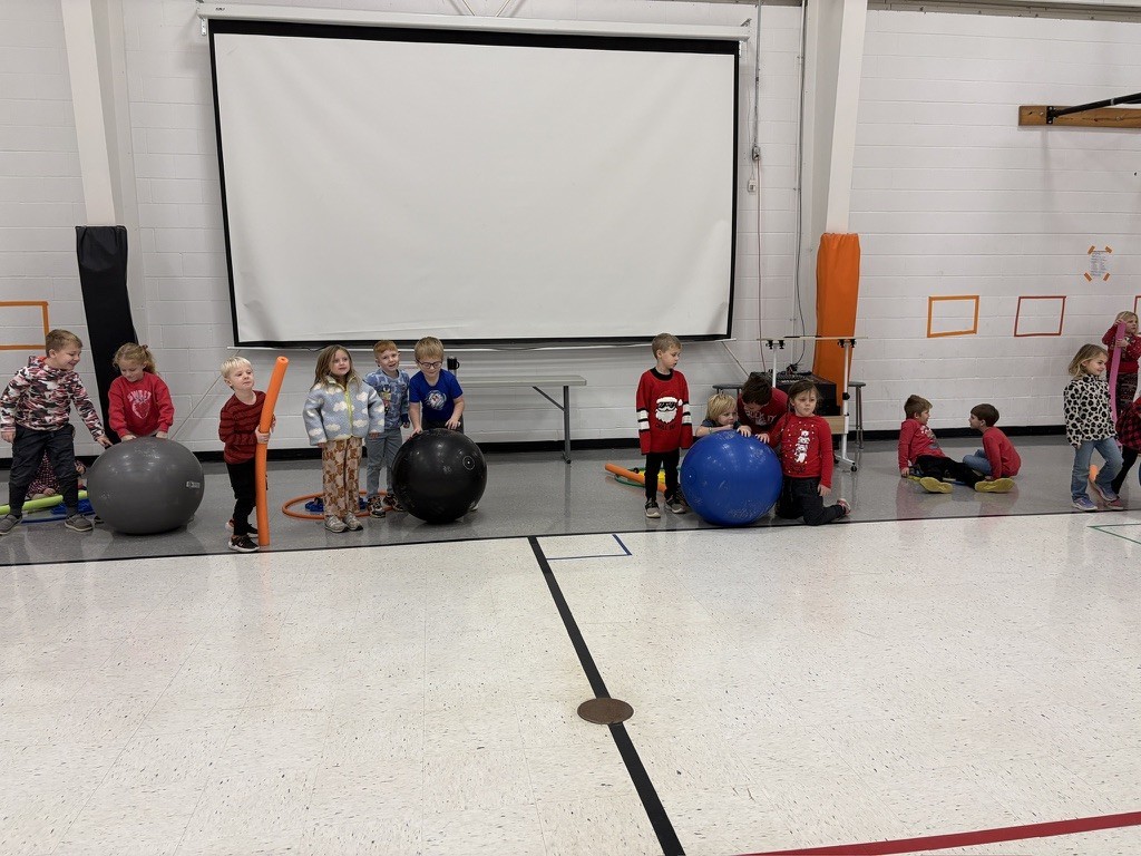 PES Students play reindeer games, rolling giant snowballs in gym