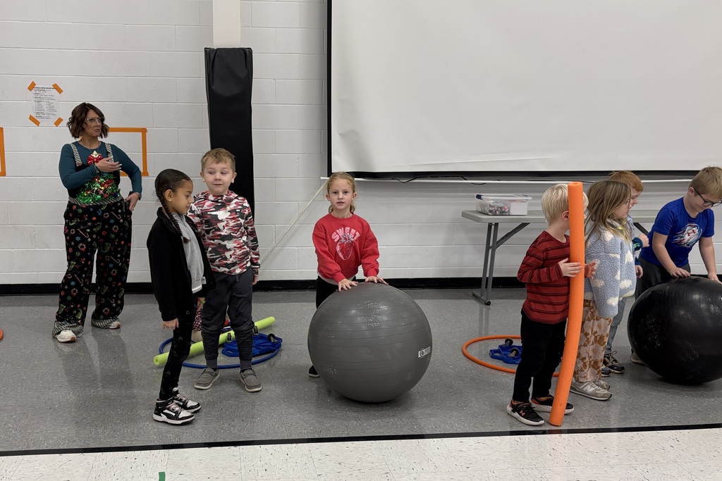 PES Students play reindeer games, rolling giant snowballs in gym