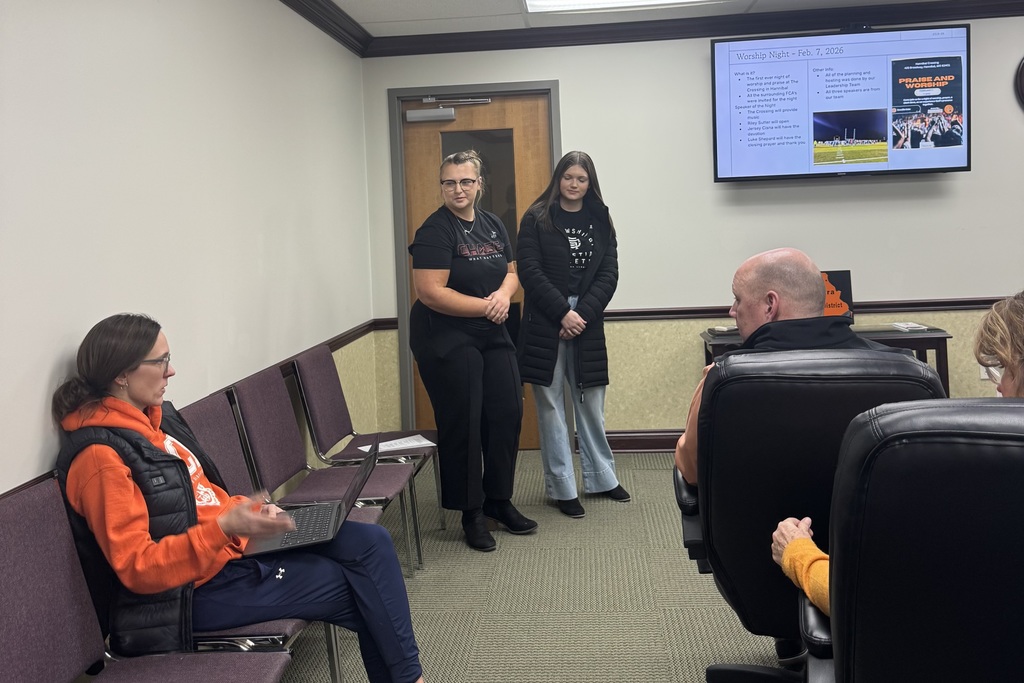 FCA sponsor and students present at board meeting