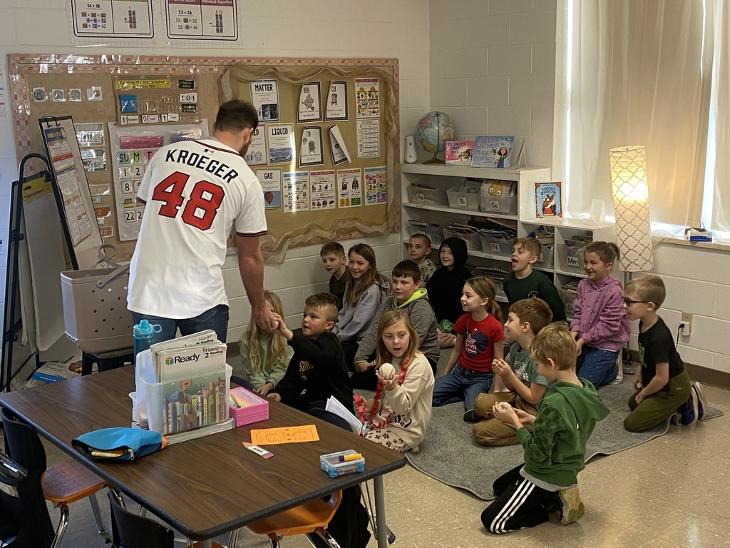 Mr. Jacob with the 2nd grade students and their baseballs
