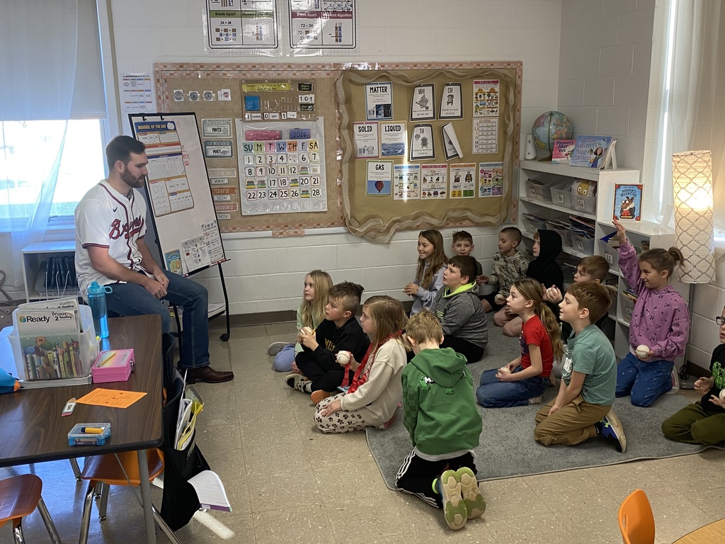Mr. Jacob with the 2nd grade students and their baseballs