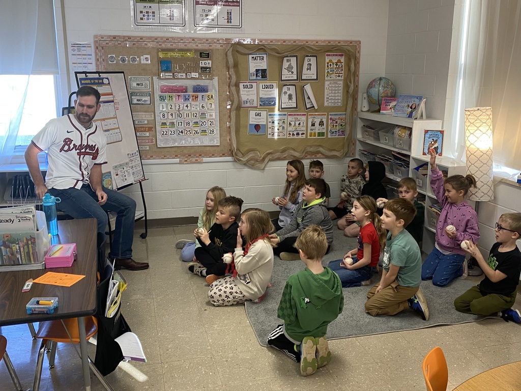 Mr. Jacob with the 2nd grade students and their baseballs