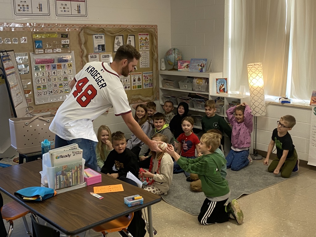 Mr. Jacob with the 2nd grade students and their baseballs