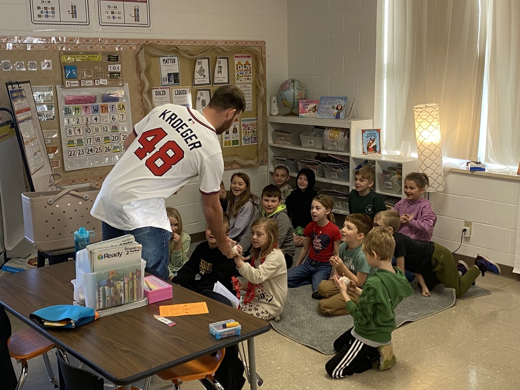 Mr. Jacob with the 2nd grade students and their baseballs