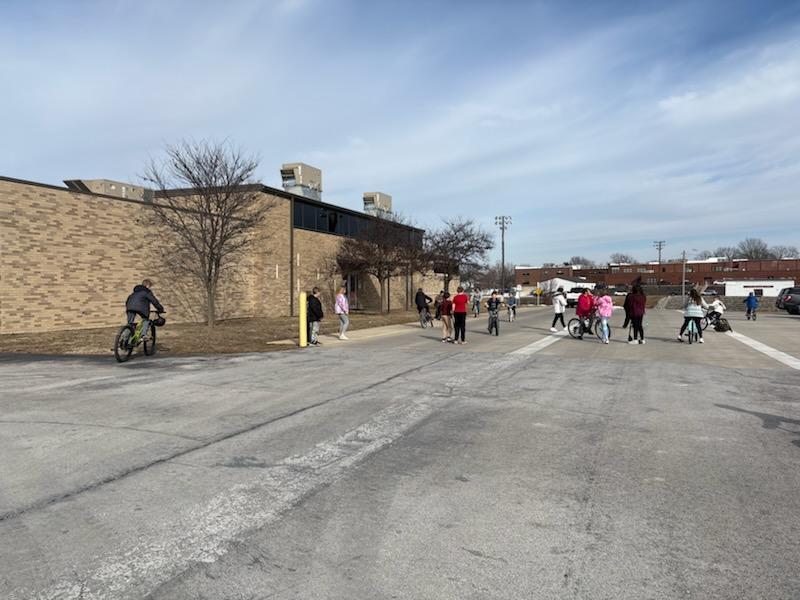 PES 4th grade students enjoying outside time riding their bikes and scooters