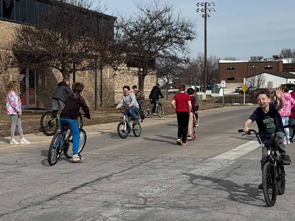 PES 4th grade students enjoying outside time riding their bikes and scooters