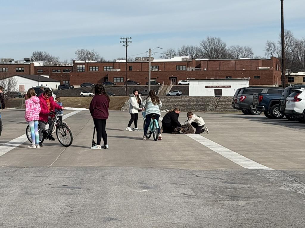 PES 4th grade students enjoying outside time riding their bikes and scooters