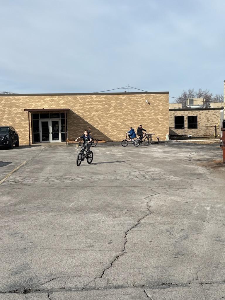 PES 4th grade students enjoying outside time riding their bikes and scooters
