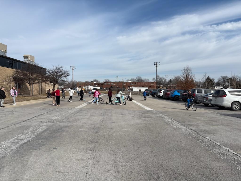 PES 4th grade students enjoying outside time riding their bikes and scooters