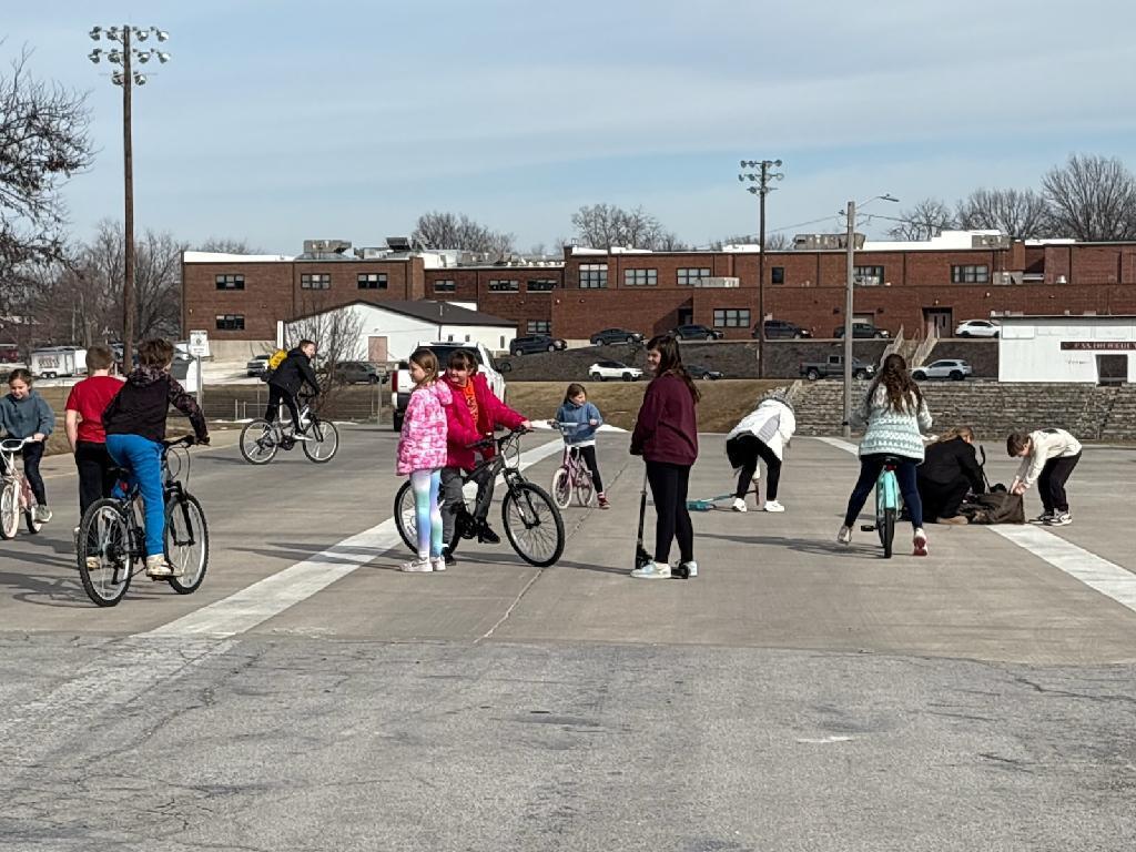 PES 4th grade students enjoying outside time riding their bikes and scooters