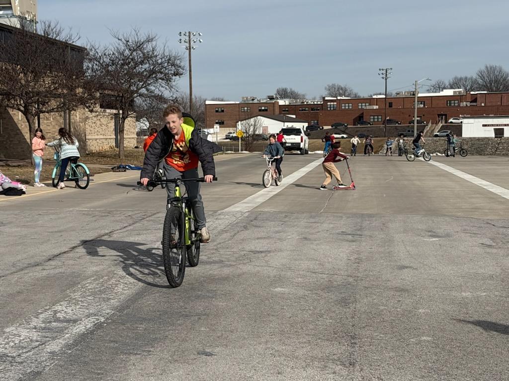 PES 4th grade students enjoying outside time riding their bikes and scooters
