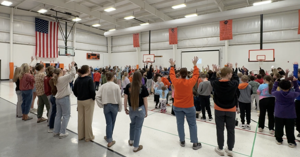 Palmyra Panthers in the gym at morning assembly singing the cheer