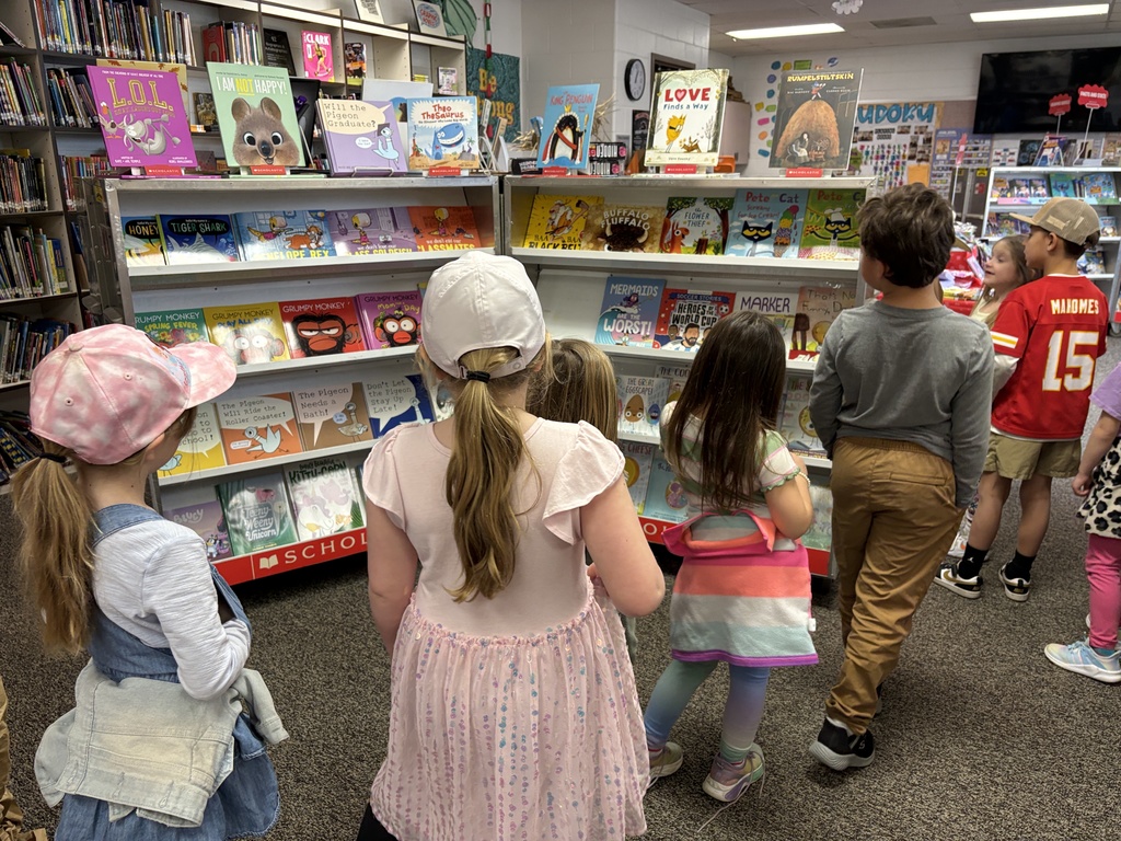 Kindergarten students viewing book fair items for sale