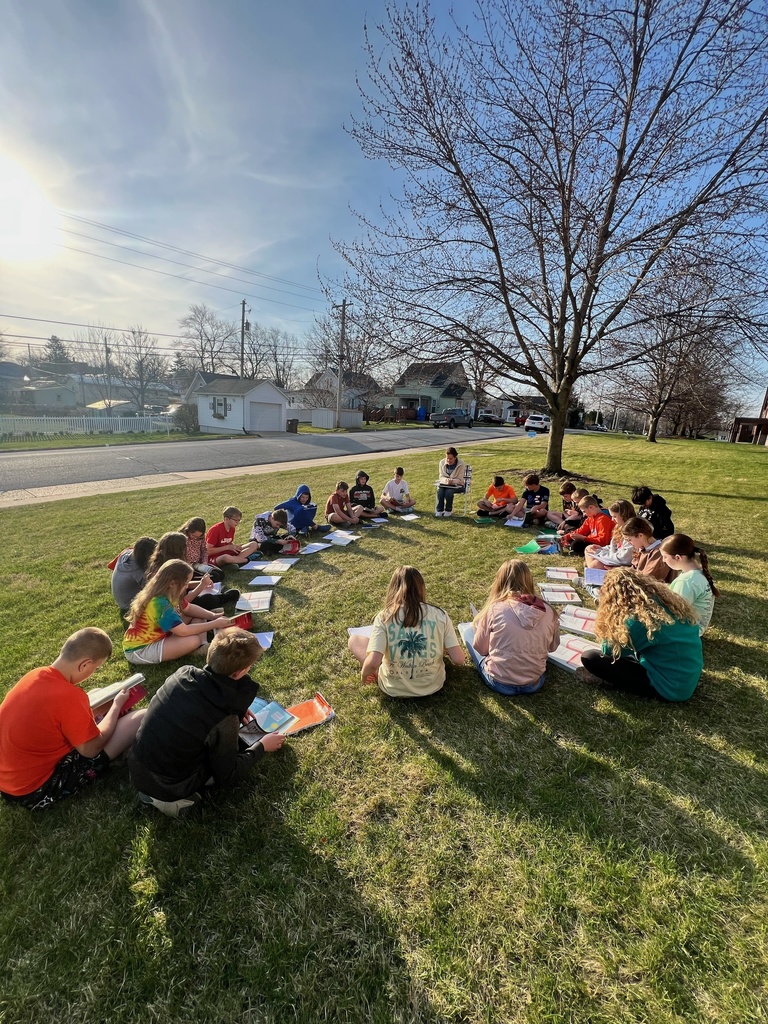 MS students sitting outside working in the sun