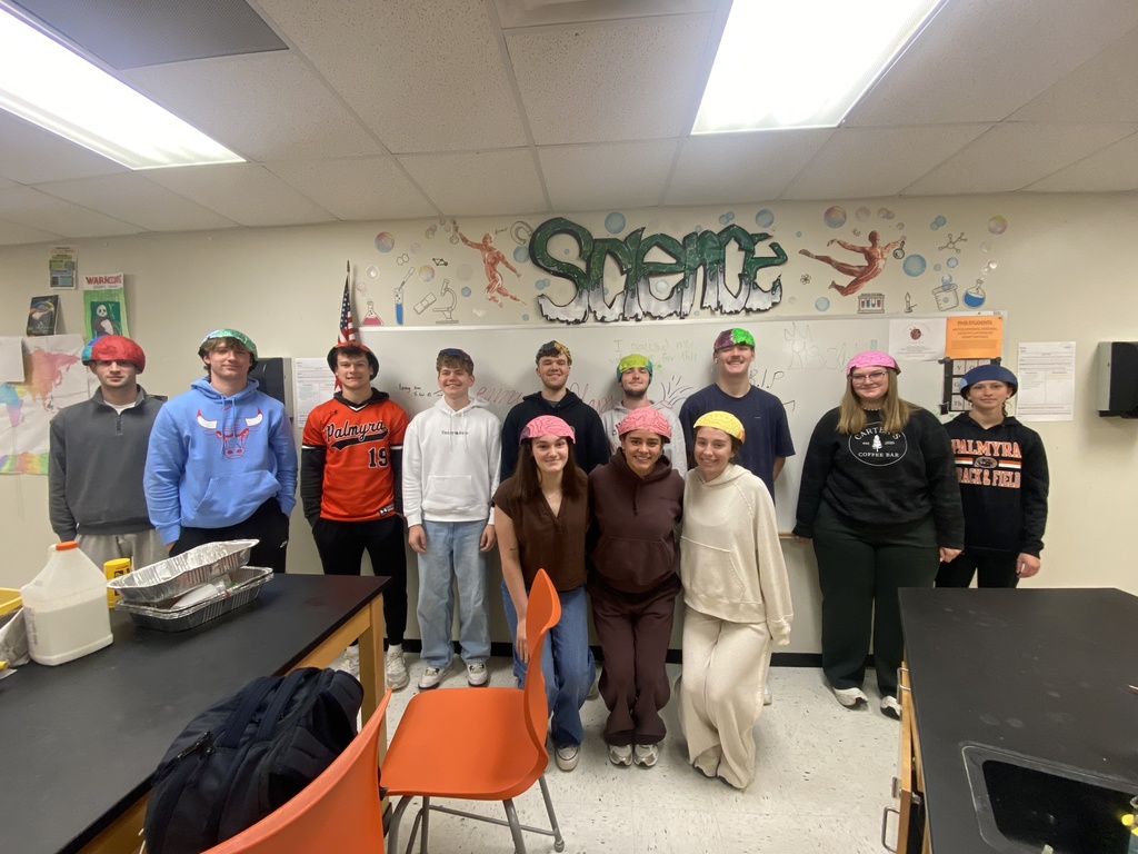 students wearing their thinking caps they made in science class