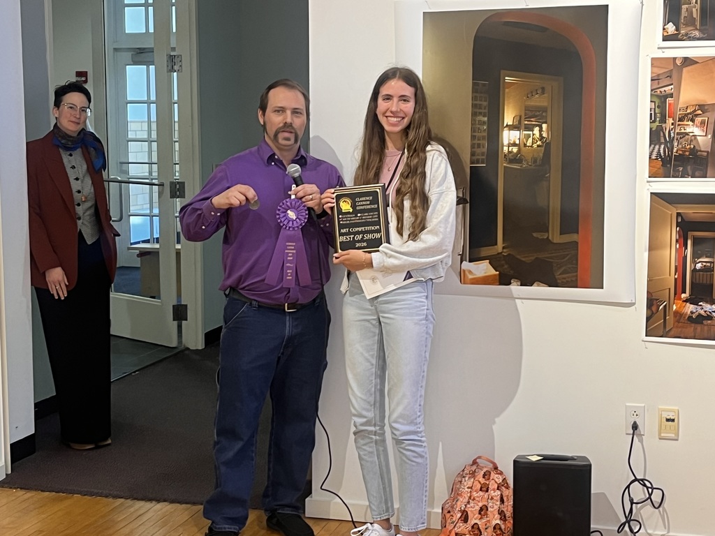 student receiving award at art show