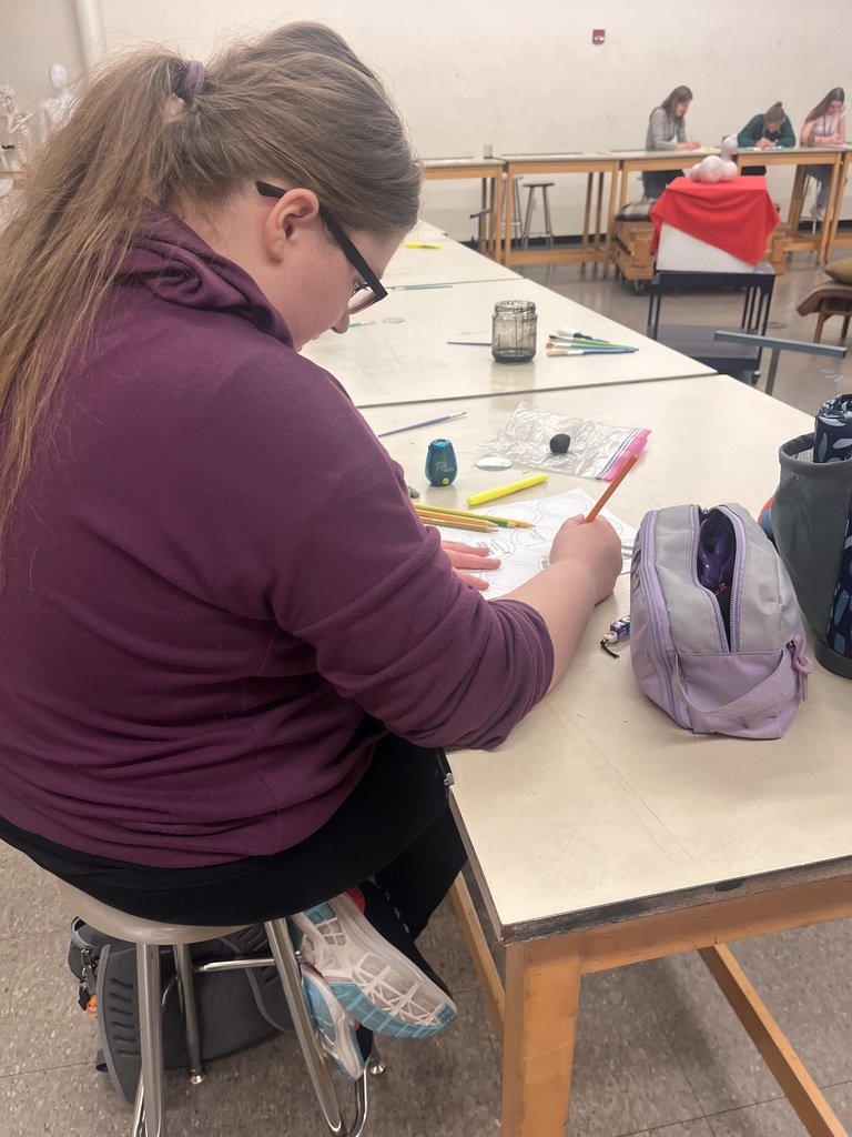 Art student working on artwork at CCC art show at Truman State University