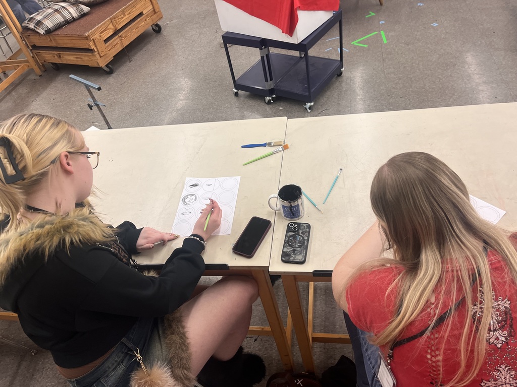 Art student working on artwork at CCC art show at Truman State University