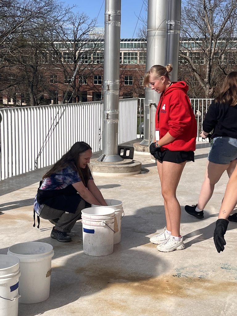 Art student working on artwork at CCC art show at Truman State University