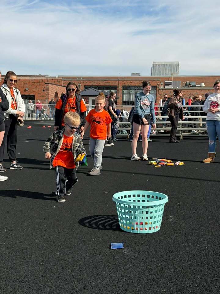 Students compete at Special Olympics with staff and buddies watching
