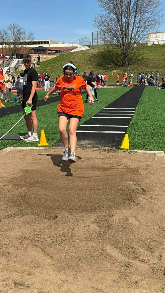 student competing in long jump at Special Olympics