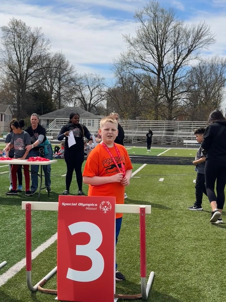 student receiving award at Special Olympics