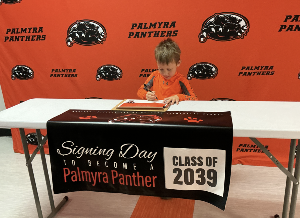 Palmyra Panther signing day Class of 2039, student signing paper