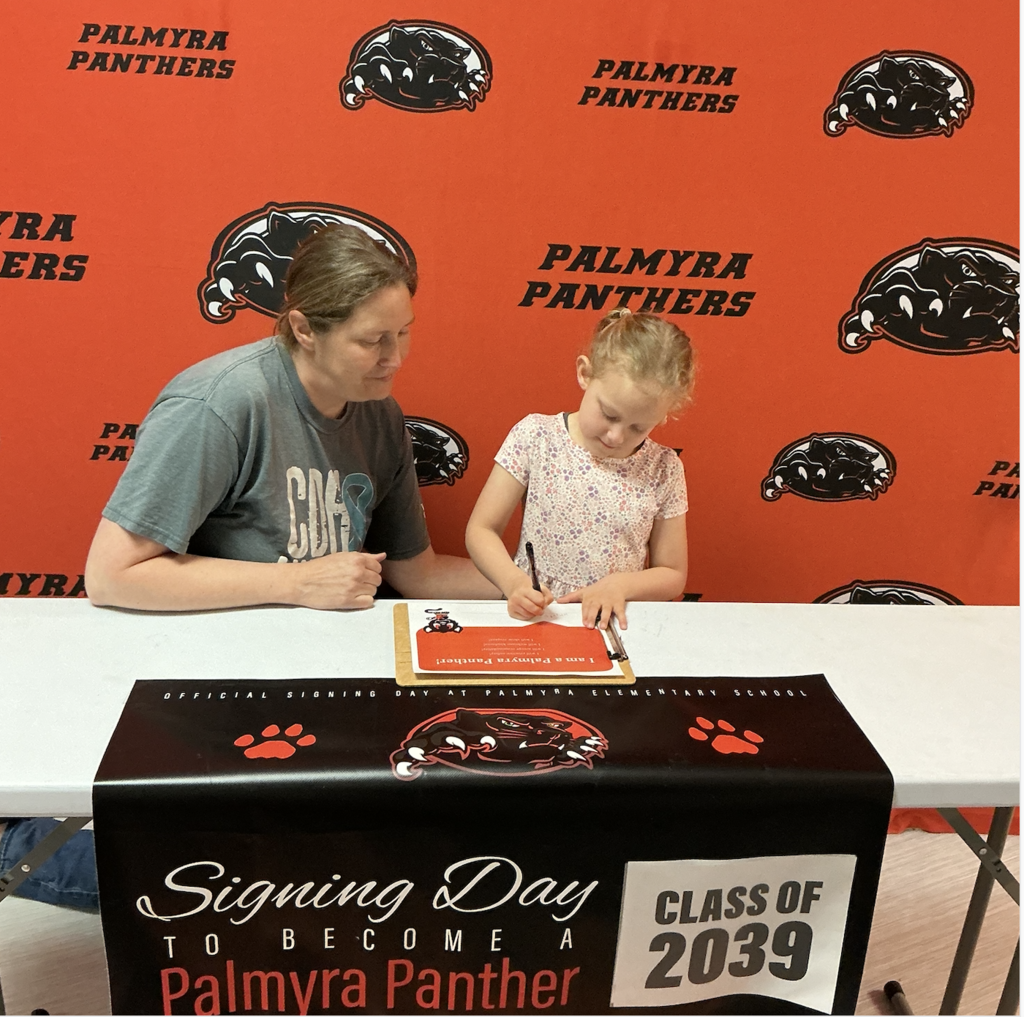 Palmyra Panther signing day Class of 2039, mom and student signing paper