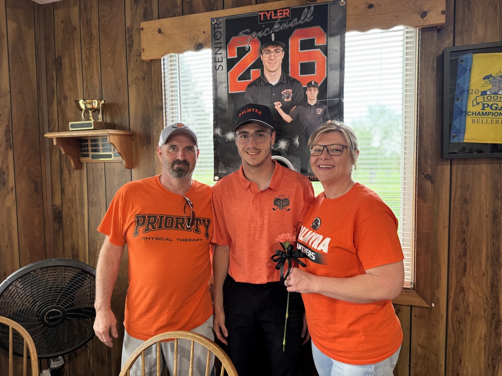 Senior night recognition, student with parents holding orange carnation