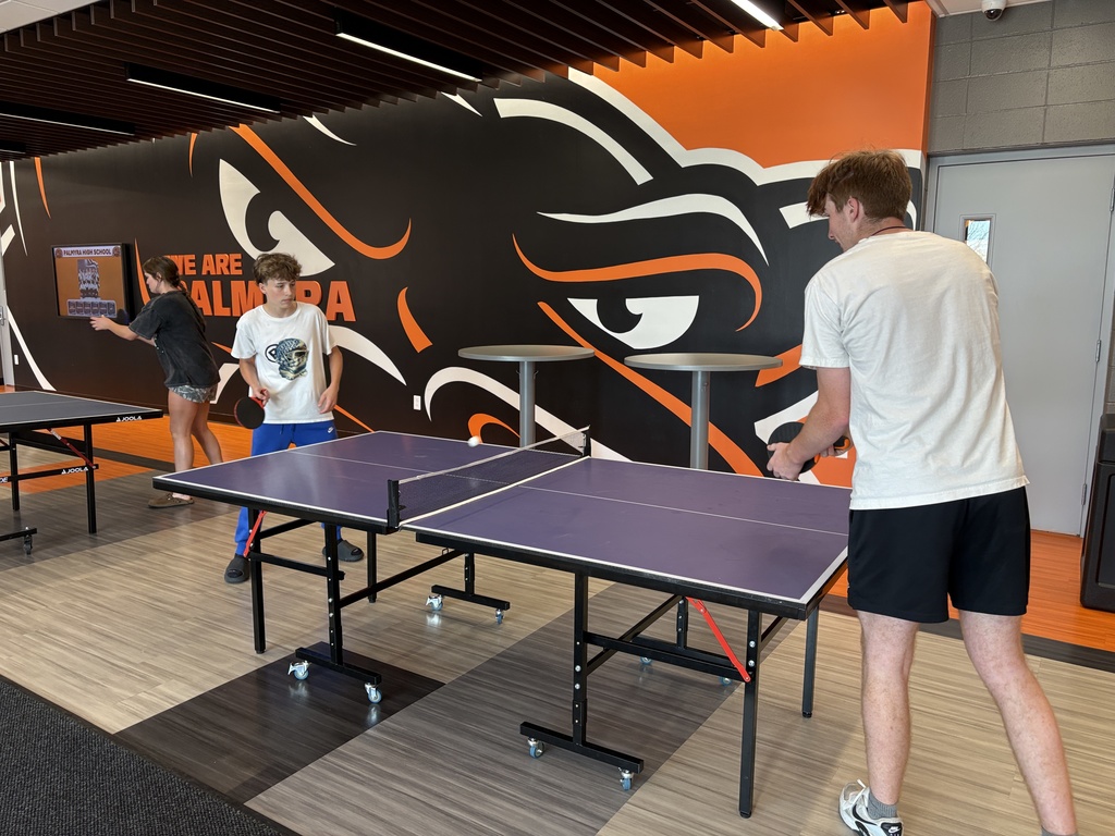 Fitness class playing ping pong