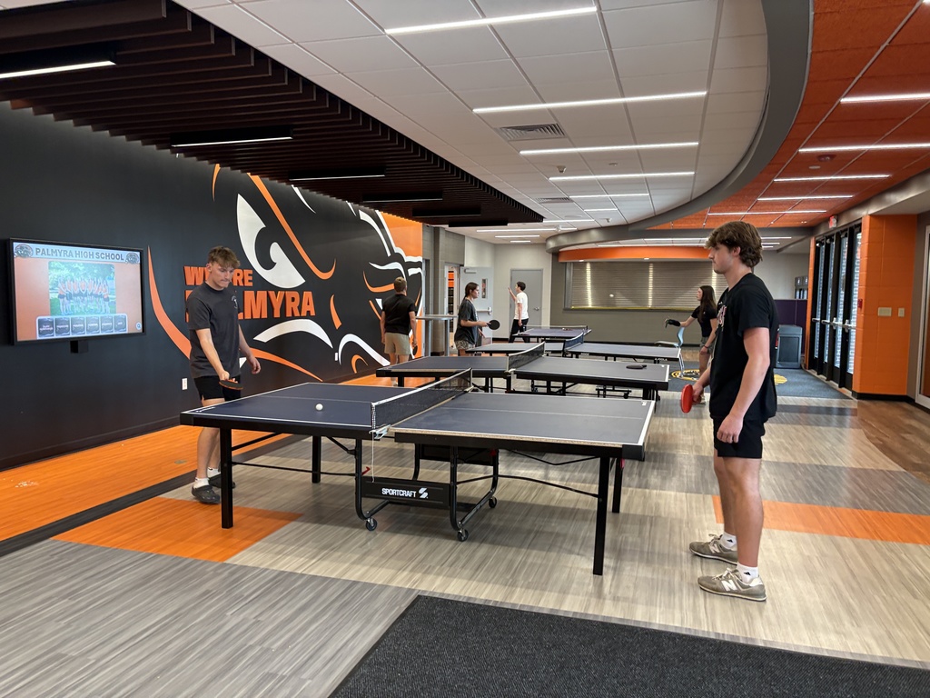 Fitness class playing ping pong