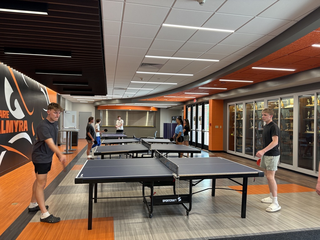 Fitness class playing ping pong