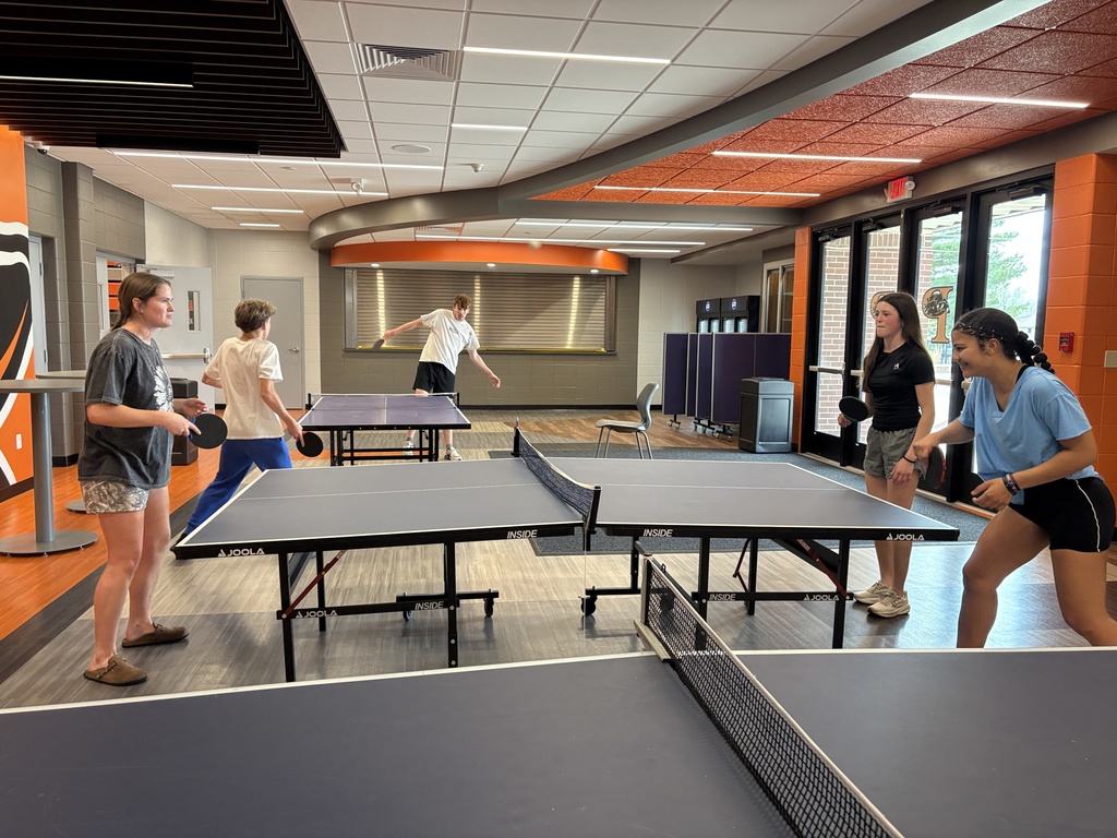 Fitness class playing ping pong