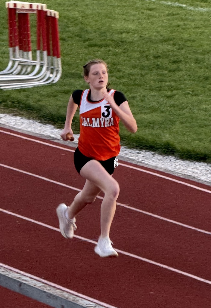 student running on track during track competition
