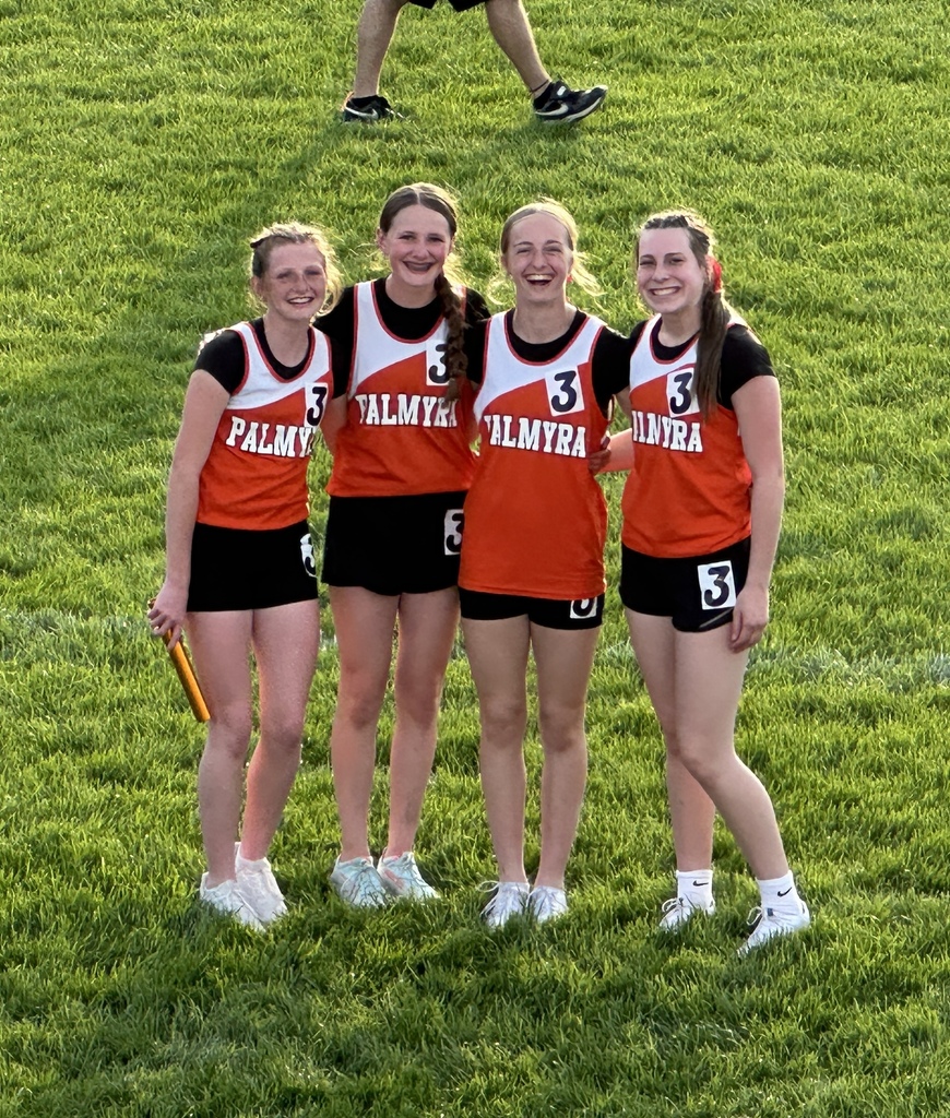 4 students preparing for their relay race with 1 holding a baton