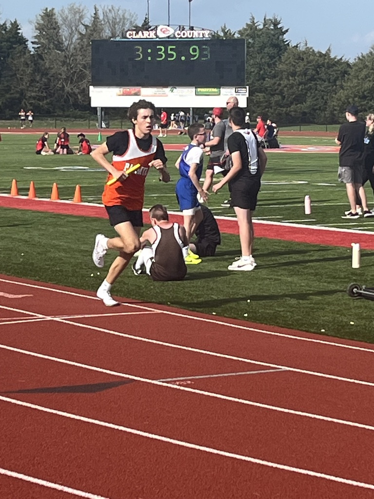 student running on track during track competition
