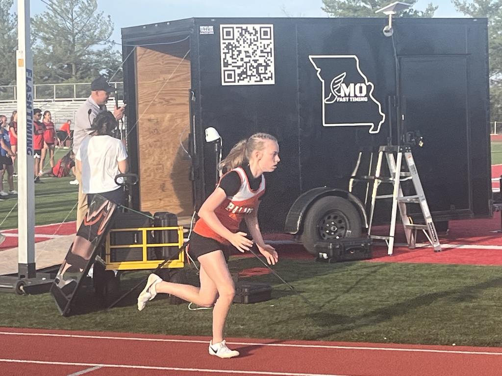 student running on track during track competition