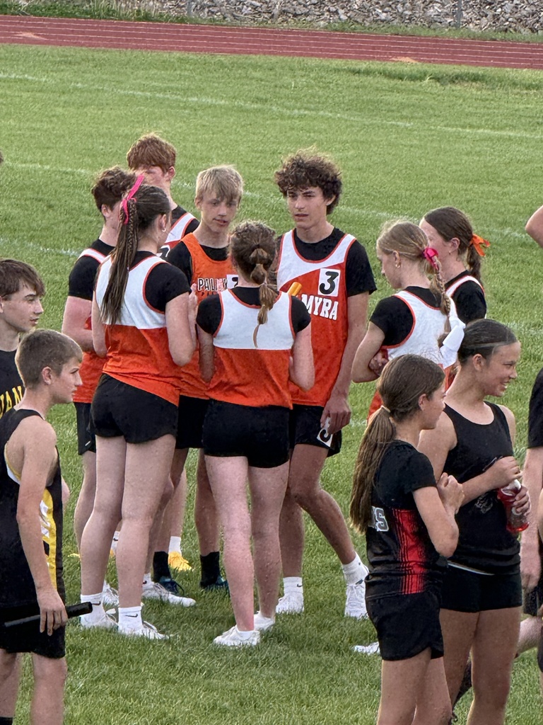 relay racers in huddle before start of their races