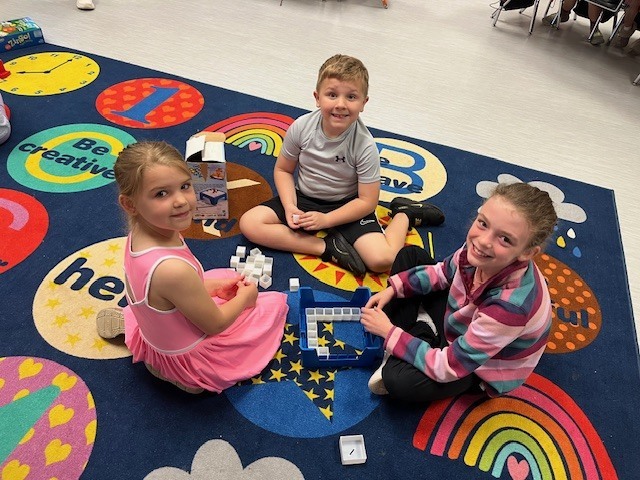 4th grade PACE student playing a game with kindergarten students