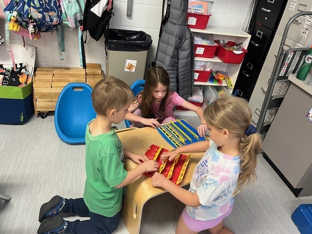 4th grade PACE student playing a game with kindergarten students