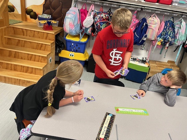 4th grade PACE student playing a game with kindergarten students