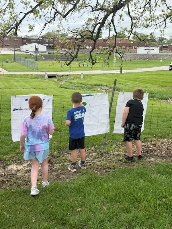 Kindergarten students exploring nature outside today painting 
